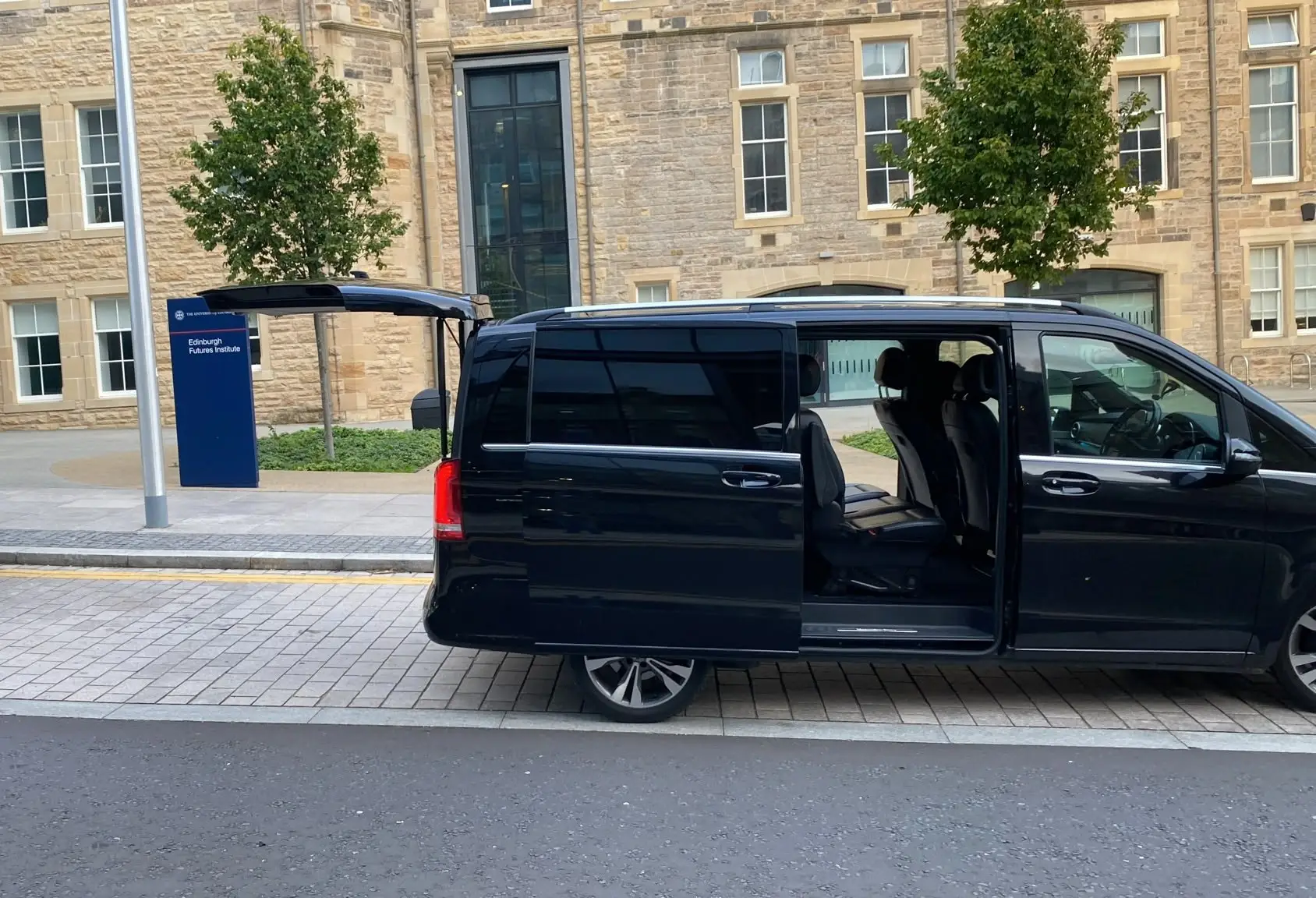 The V-Class with sliding door and tailgate open outside the Edinburgh Futures Institute