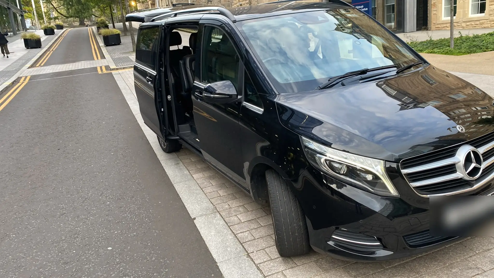 The front of the Mercedes V-Class, door open, ready for passengers